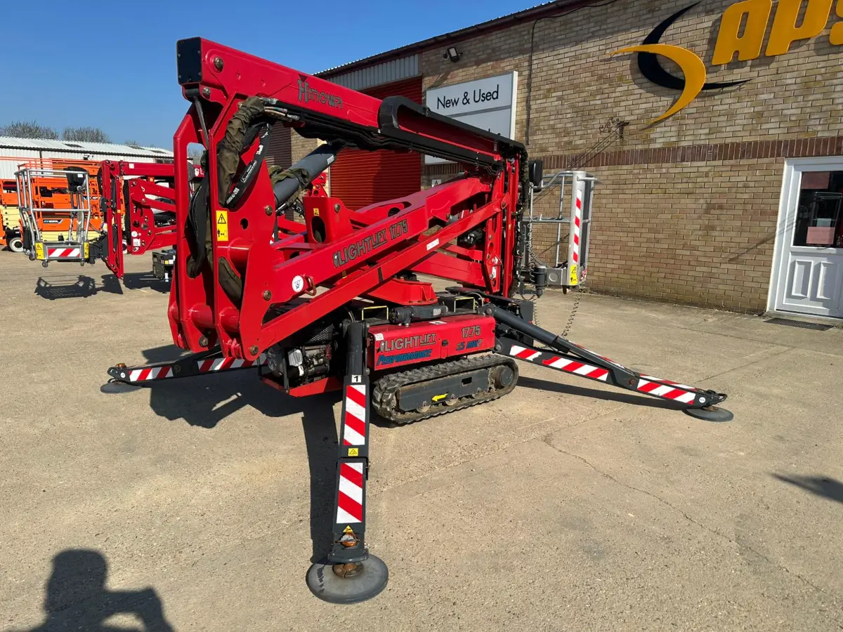 Hinowa Lightlift 17.75 tracked spider lift with outriggers deployed in the yard